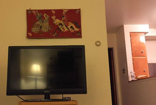 The Jousting tapestry hanging above a TV